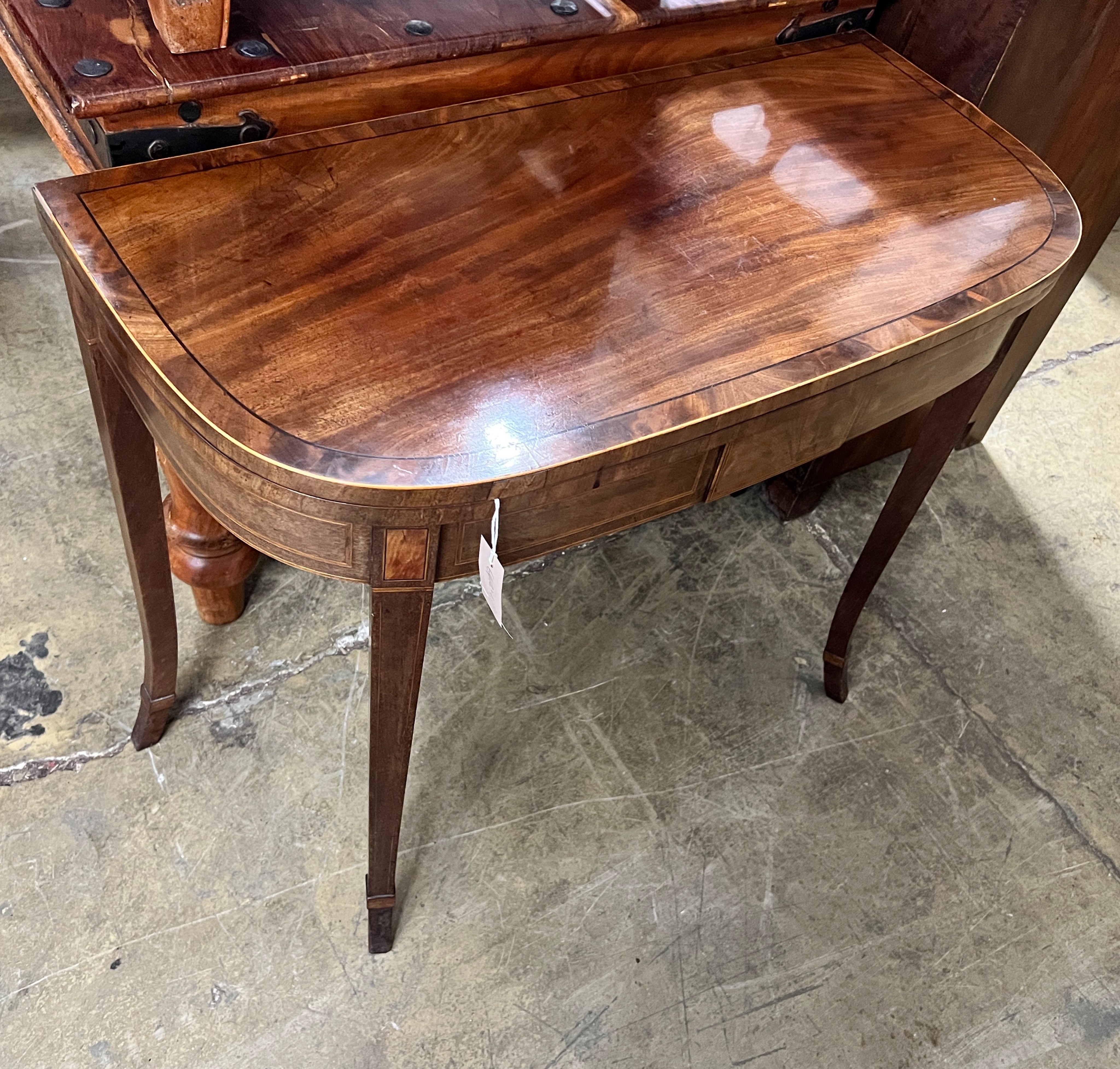 A George III banded mahogany D shaped folding card table, width 89cm, depth 43cm, height 73cm